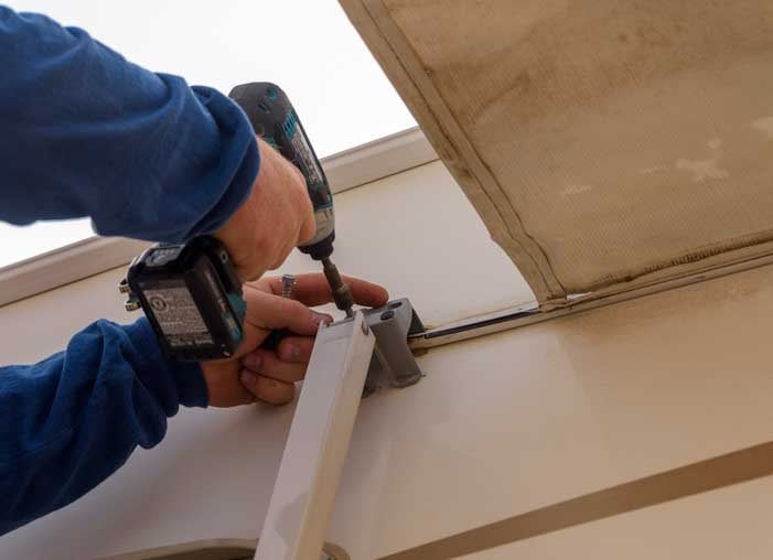 03 701 Remove the bolts attaching RV awning to the side of the fifth wheel trailer min